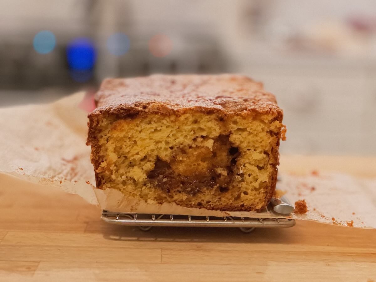 A cross-section of a golden loaf with a brown sugar swirl in the middle.